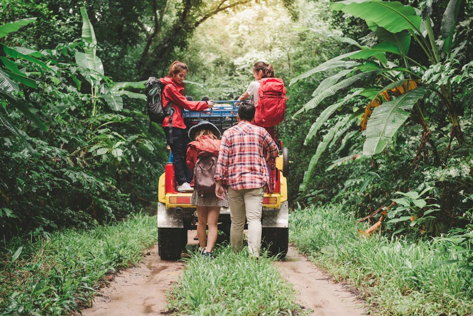 Friends hiking in a tropical forest, riding a jeep with backpacks, enjoying the adventure