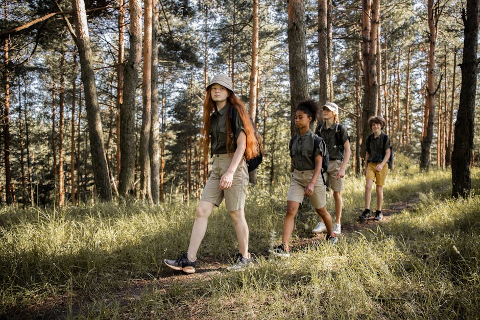 Group of teenagers hiking through a forest trail, enjoying nature and exploration
