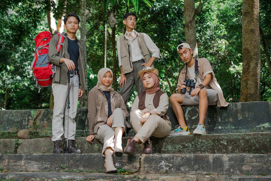 A group of young tourists enjoying a hiking adventure in a lush jungle setting in Lampung, Indonesia
